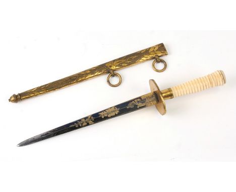 An early 19th century French stiletto dagger with blue &amp; gilt tapering blade, turned ivory handle in a gilt metal scabbar