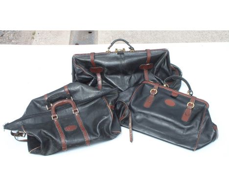 A graduated set of Bugatti style leather luggage with lacquered brass fittings, the largest approx 60cms (24ins) wide (3).