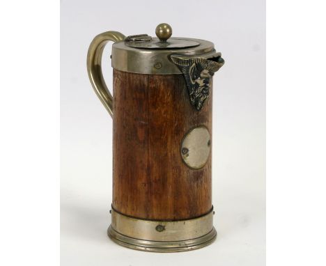A late 19th century oak and silver plated jug with ceramic liner, with a Bacchus form spout, 24cms (9.5ins) high.Condition Re