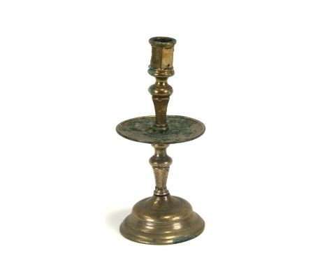 A Persian bronze / brass candlestick, 26cms (10.25ins) high.