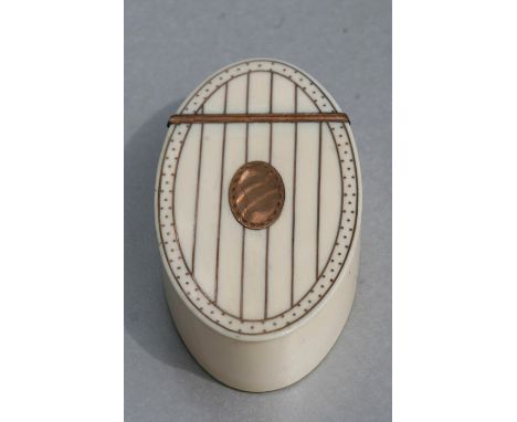 A Georgian ivory oval snuff box with yellow metal decoration and yellow metal oval blank cartouche to the top, 8.5cms (3.25in
