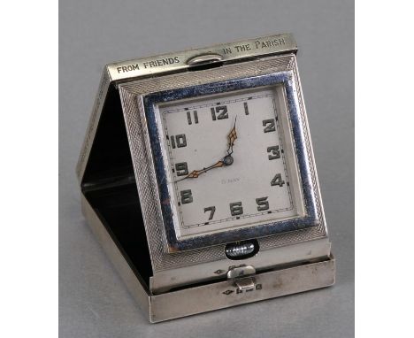 A silver eight-day travel clock, Birmingham 1934, the case initialled 'JEHL' with inscription.