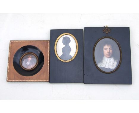 A three quarter length silhouette depicting a young lady in an ebonised frame; together with two portrait miniatures (3).