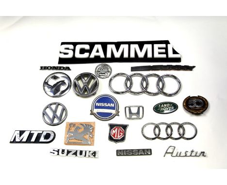 A large quantity of various marque bonnet insignias for various models including Volkswagen, Nissan, Vauxhall, Audi, Land Rov