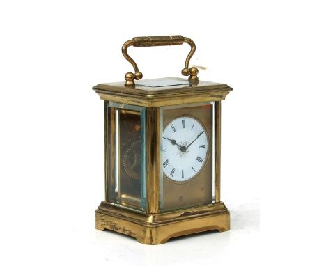 A miniature four-pillar gilt brass carriage clock, the white enamel dial with Roman numerals, 5cms (2ins) wide.