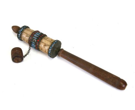 A Tibetan prayer wheel with jade type carved panels, 25cms (10ins) long.