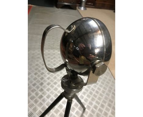 An A pillar chrome bodied spot lamp, approx. 12cm, (4 ins) diameter, on tripod base, overall height 60cm, (24 ins)
