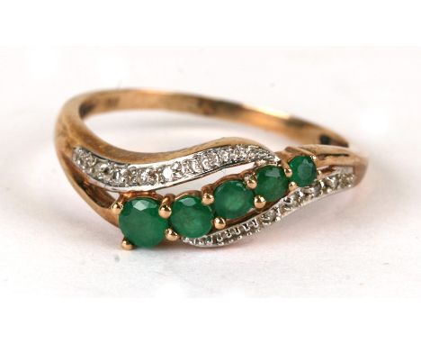 A 9ct gold diamond and emerald ring, weight 2.2g, approx UK size 'R'.