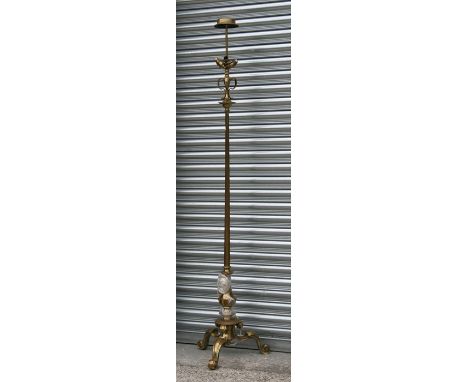 A large late 19th century / early 20th century brass standard lamp on tripod base.