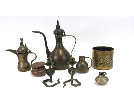 A group of Indian / Islamic brassware to include a dallah coffee pot; a wine ewer; a pair of cobra candlestick, the largest 3