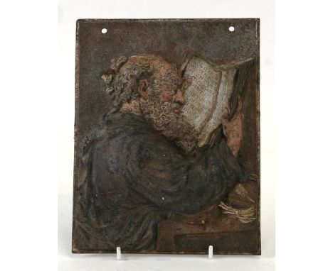 A cold painted cast iron plaque depicting a monk reading a manuscript, 16 by 21cms (6.25 by 8.25ins).