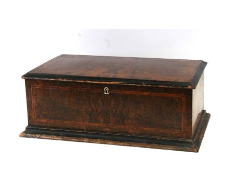 A 19th century music box with seven bells within a walnut case, 50cms (19.5ins) wide.Condition ReportThis is not in good work