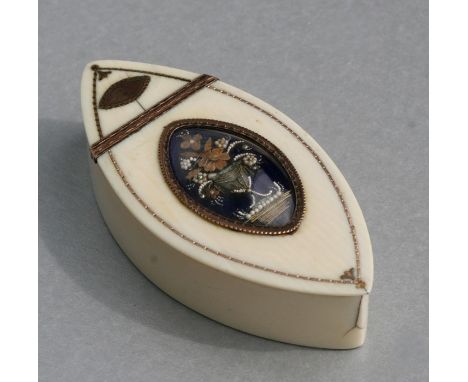 An 18th century ivory snuff box of navette form with yellow metal inlay and having a blue enamel memorial panel to the lid de