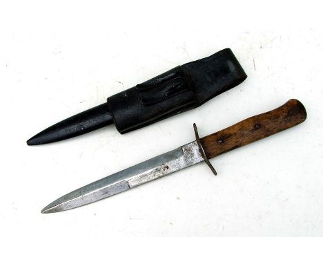 A WW2 German fighting knife with wooden studded grip handle in its steel scabbard with leather frog. Blade length 16.5cms (6.