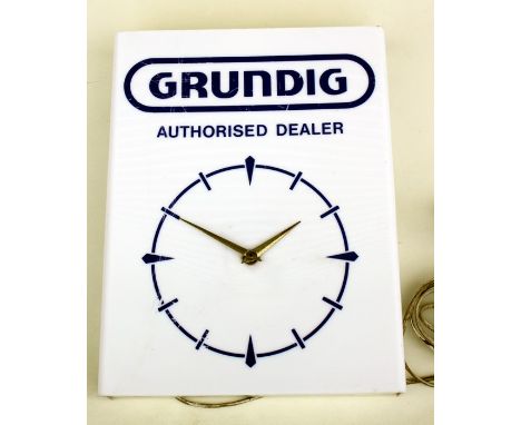 An original GRUNDIG authorised dealer electric wall clock, 30cm (12 ins) wide