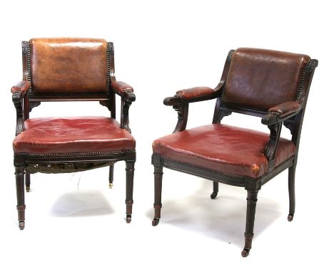 A pair of Regency carved mahogany library chairs with red leather back cushion and seats, with acanthus leaf carved scroll ar