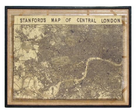 A large print of Stanford's Map of Central London, framed and mounted on hessian, overall 103 by 82cms (40.5 by 32.5ins).