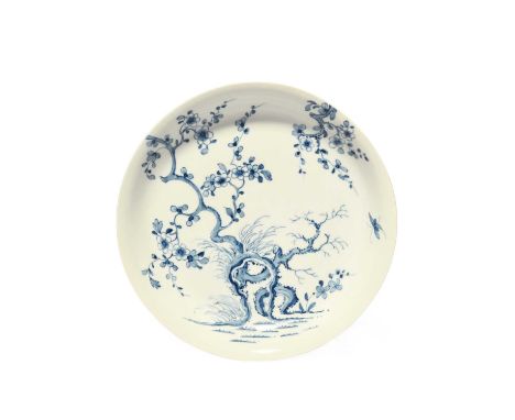 A good Worcester saucer dish, c.1758, painted in a pale blue with the Prunus Root pattern, with flowering branches extending 