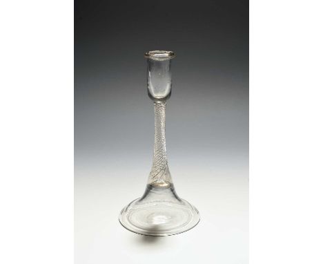 An early glass candlestick, c.1700, the slender sconce with an applied string rim, over a tapering airtwist stem and a tall c