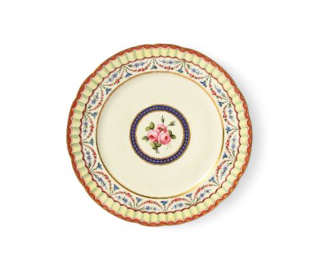 A Sèvres plate, the porcelain 18th century, probably later decorated with a central roundel of pink roses within a garland an