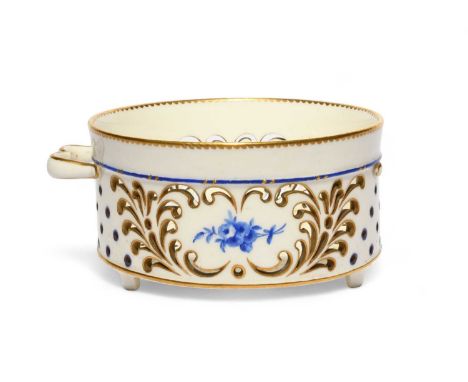 An early Sèvres or Vincennes cheese dish (fromager), c.1754-59, the shallow cylindrical form pierced with elaborate scroll de