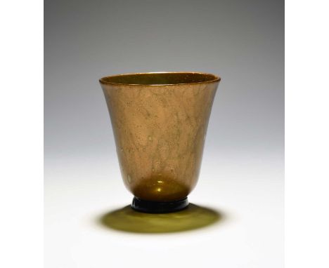A façon de Venise beaker, 18th century, the U-shaped form with gilt or bronze powdered inclusions, raised on a circular foot,