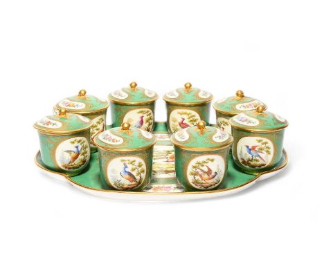 A Continental porcelain set of eight custard cups and covers with stand, late 19th century, painted in the Sèvres style with 
