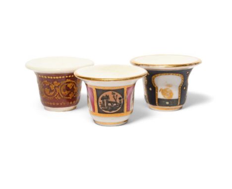 Three Paris porcelain rouge pots, c.1800-30, one decorated with a gilt foliate scroll band on a claret ground, another with s