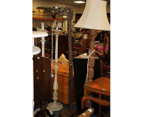 A HEAVILY CARVED ORIENTAL STYLE LAMP STANDARD