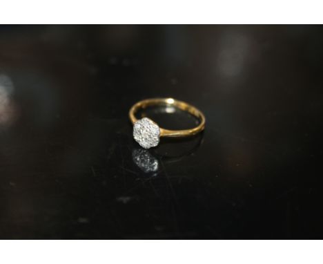 A LADIES 18CT GOLD FLORAL SET DIAMOND RING