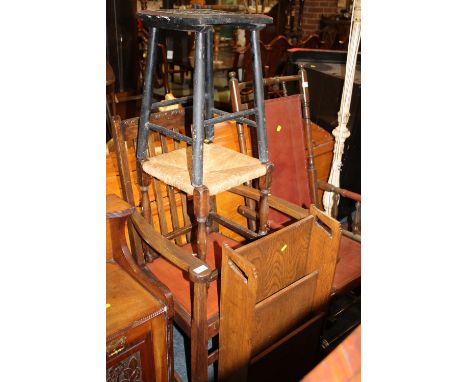 A 1920'S OAK ARMCHAIR, OAK BOOK TROUGH AND TWO STOOLS (4)