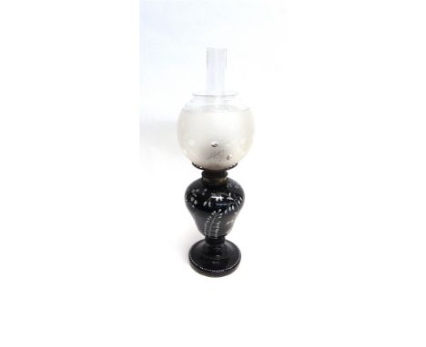 AN EDWARDIAN OIL LAMP  the opaque glass base with foliate decoration, with frosted glass spherical shade, 55cm high overall
