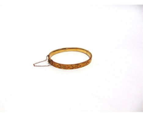 A 9 CARAT GOLD HINGED BANGLE  half engraved decoration, 6mm wide, 6.2cm internal diameter, 9.4g gross 