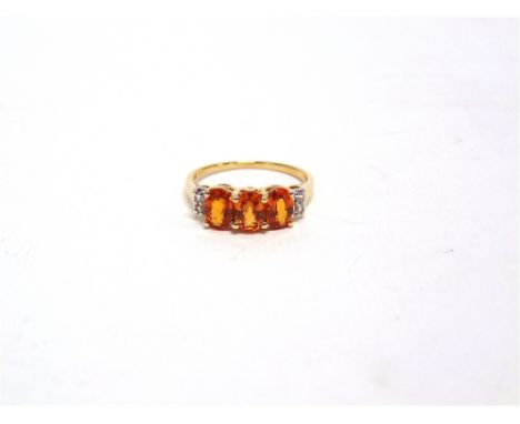 A THREE STONE FIRE OPAL GOLD RING with stone set shouldering finger size L1/2, 2g gross