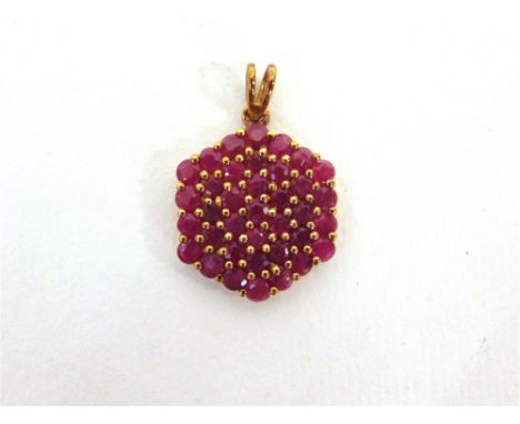 A RUBY CLUSTER 9 CARAT GOLD PENDANT  of hexagonal outline, 3g gross