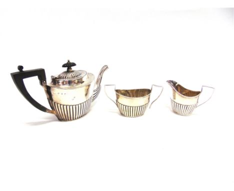 A LATE VICTORIAN SILVER THREE PIECE BACHELOR TEA SERVICE  maker J.M.B., Birmingham 1896, of oval gadrooned form, 387g (12.4 t