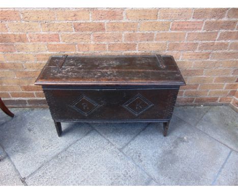 AN OAK SIX PLANK COFFER  the front carve with initials 'R' and 'K' within lozenges, 91cm wide 35cm deep 50cm high