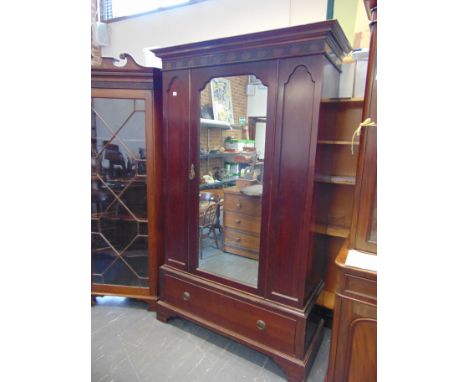 A MAHOGANY WARDROBE  with mirror door and single long drawer below and on bracket feet, height 302cm, width 129cm, depth 54cm