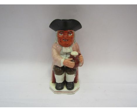 A 19th Century toby jug depicting a gentleman with pipe and jug of ale. a/f. 24cm tall