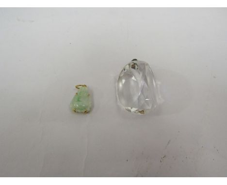 A rock crystal pendant and a jade Buddha pendant