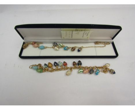 A Bradford Exchange "Treasures of the Heart" charm bracelet with 22ct gold plated and enamel egg charms and a matching neckla