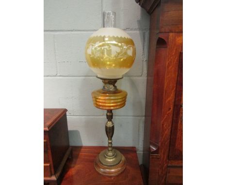 A Victorian oil lamp, the amber shade (a/f) and reservoir over brass column to beech turned base