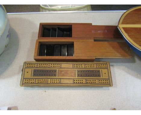 Two sets of dominoes in wooden boxes and two cribbage boards