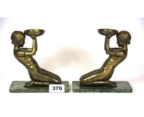 A pair of Art Deco style cold cast figural tea light holders, H. 15cms.