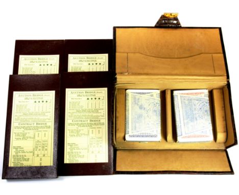 A case of vintage bridge scorers and un-opened playing cards.