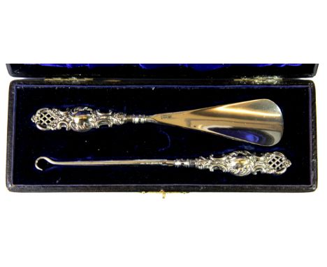 A cased hallmarked silver shoe horn and button hook.