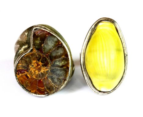 A 925 silver ring set with a shell together with a further white metal ring set with a fossil.