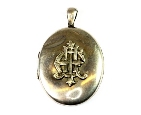 An antique white metal (tested silver) portrait locket pendant, L. 6cm.