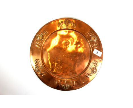 An Art Nouveau hammer copper platter stamped on the reverse for Carl Deffner, Dia. 32.5cms.