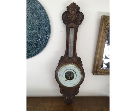 Large  antique carved oak barometer by Lloyd Payne & Amiel ltd  is approximately 35 inches long by 12 ins wide 